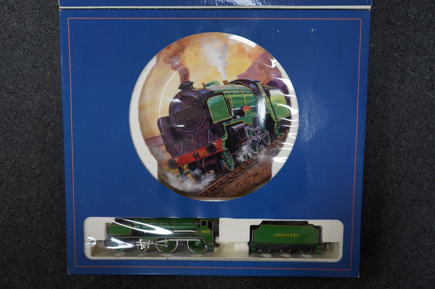 Four boxed Hornby Railways 00 gauge train packs in collaboration with Royal Doulton; an LMS Coronation Class locomotive (R459), an SR Schools Class locomotive (R648), and two GWR King Class locomotives (R650). Condition